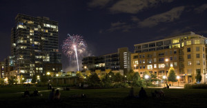 Riverfront Park at night, with Park Place Lofts on the right, the Glass House on the left, and Commons Park in the foreground. The park offers a highly attractive amenity directly adjacent to the project.