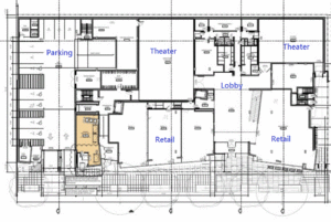 Ground floor plan of the building, showing theaters in the rear, parking to the side, and retail and residential entrances along the front. The offices are on a mezzanine above the retail, leaving double-height spaces for the theaters.